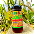 A jar of Eucabroncosol + PLUS honey displayed in front of a plant backdrop, with a label that includes the brand name and 'Reinforced with Eucalyptus and Oxygen' written on it.
